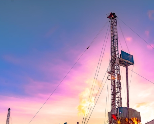 Drilling oil well at sunset