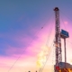 Drilling oil well at sunset