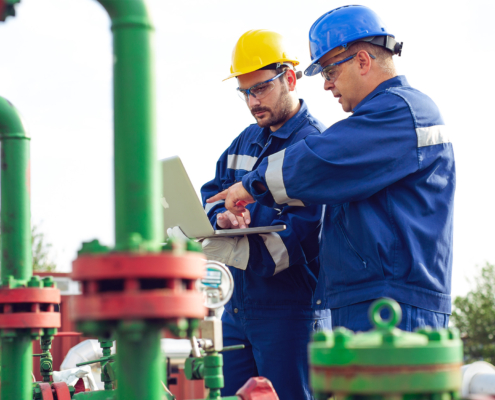 Engineer power and energy using laptop on location site